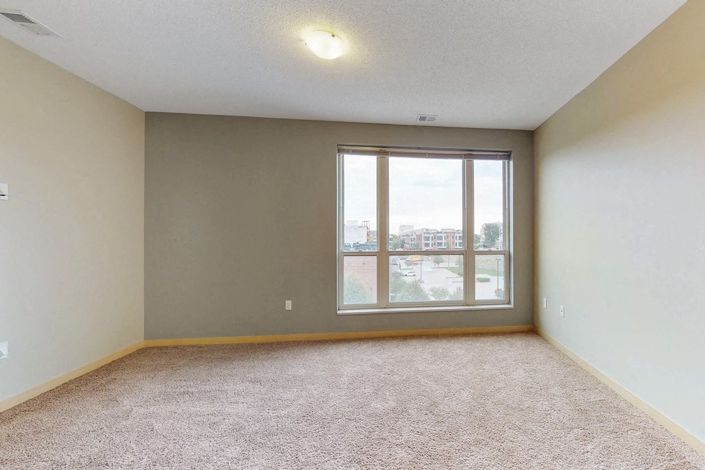 an empty living room with a large window