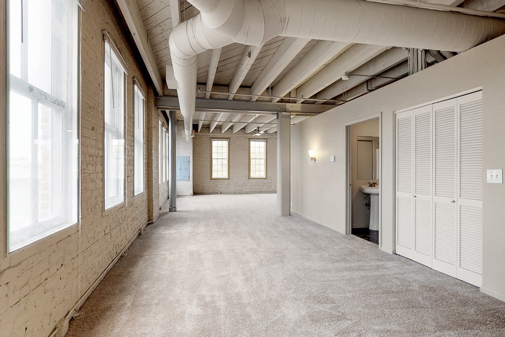 the interior of a building with a large hallway with windows and a door