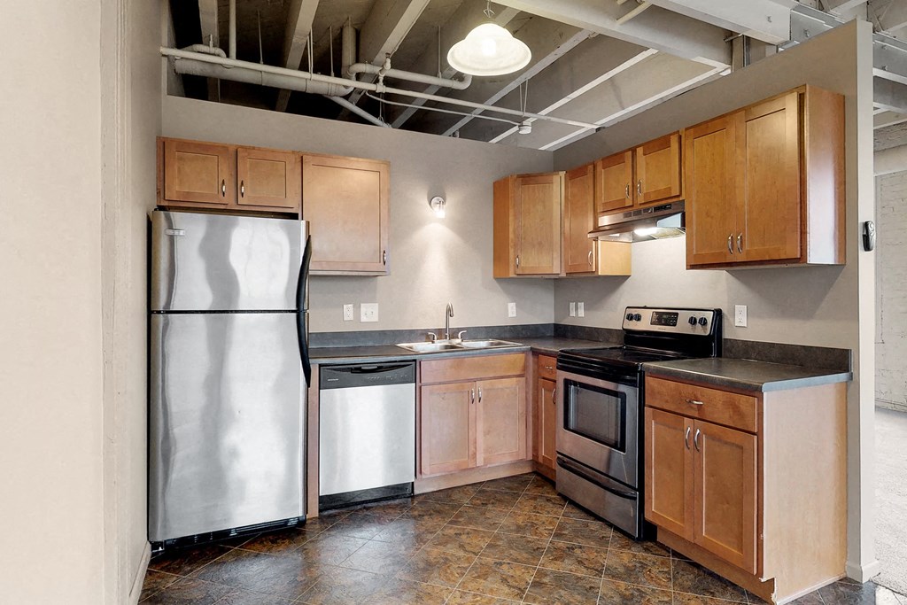 a kitchen with stainless steel appliances and wooden cabinets