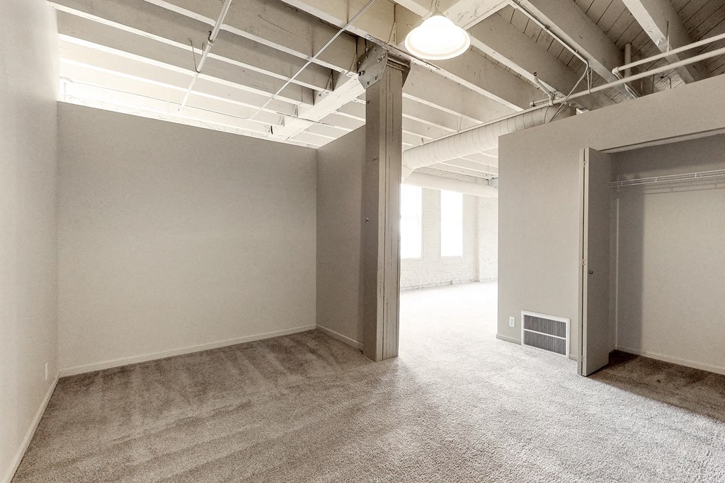 an empty room in a building with an open door