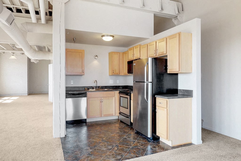 a kitchen with stainless steel appliances and wooden cabinets