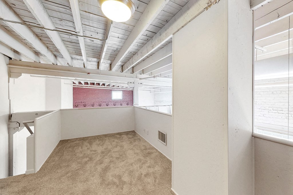 an office space with a brick wall and white ceilings