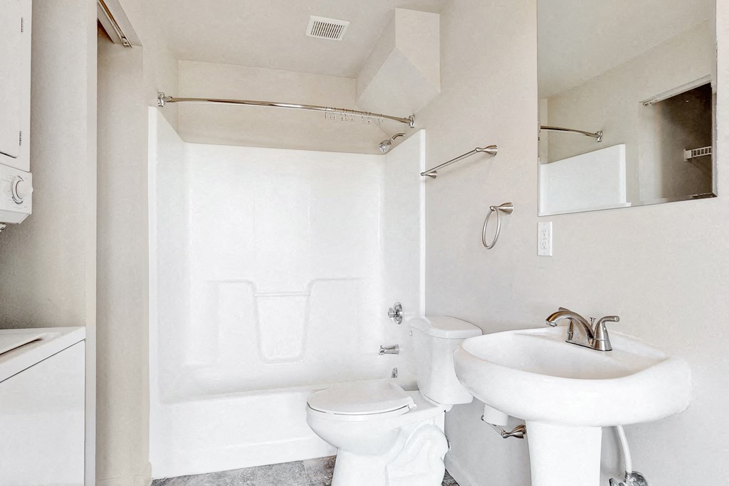 a white bathroom with a sink and a toilet