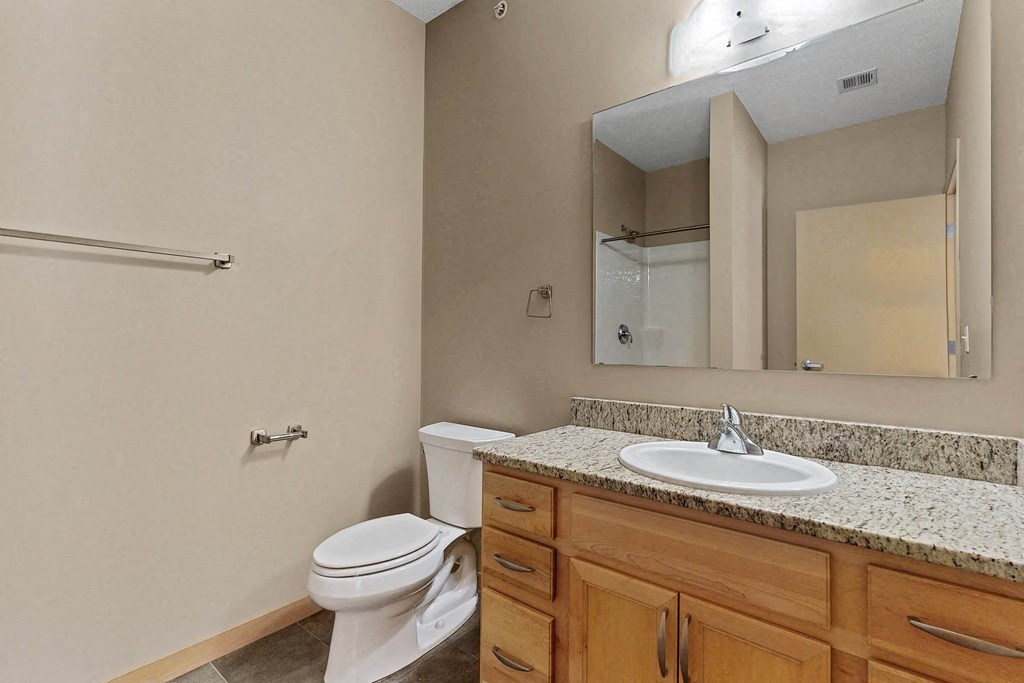 a bathroom with a sink toilet and a mirror