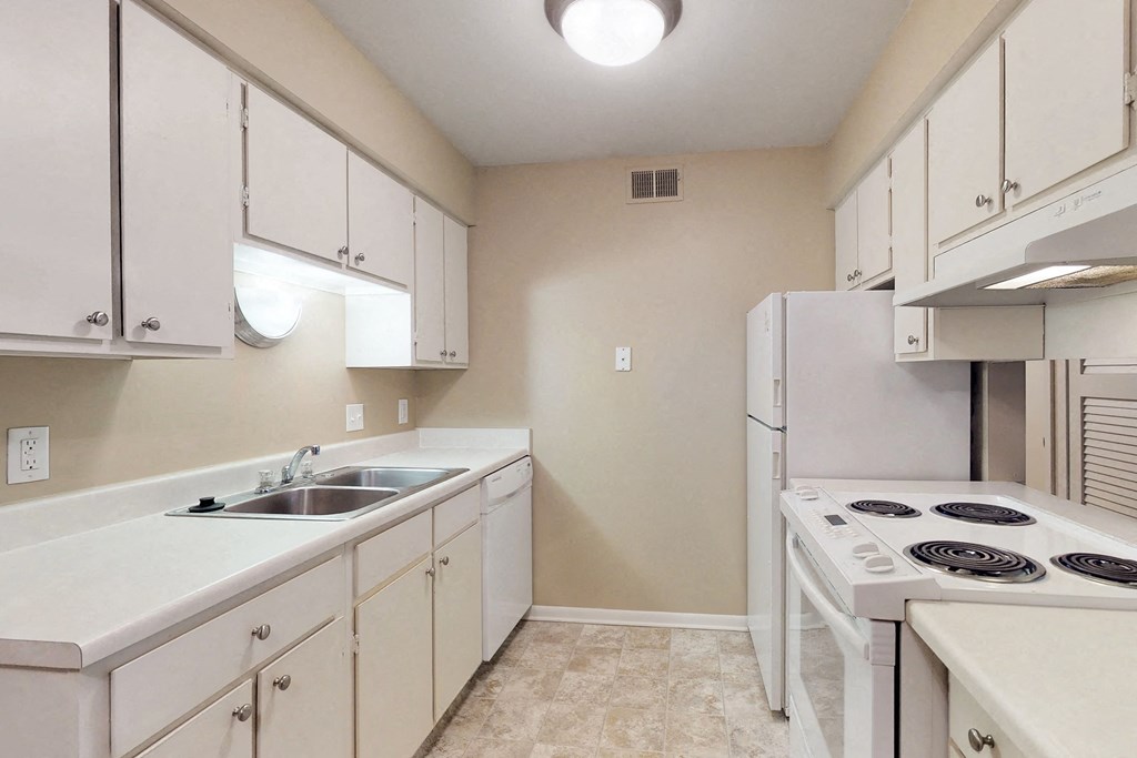 a white kitchen with white appliances and white cabinets