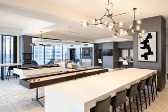 a communal table with a shuffleboard and foosball table at 220 Meridian, Indianapolis, 46204 - Photo Gallery 3