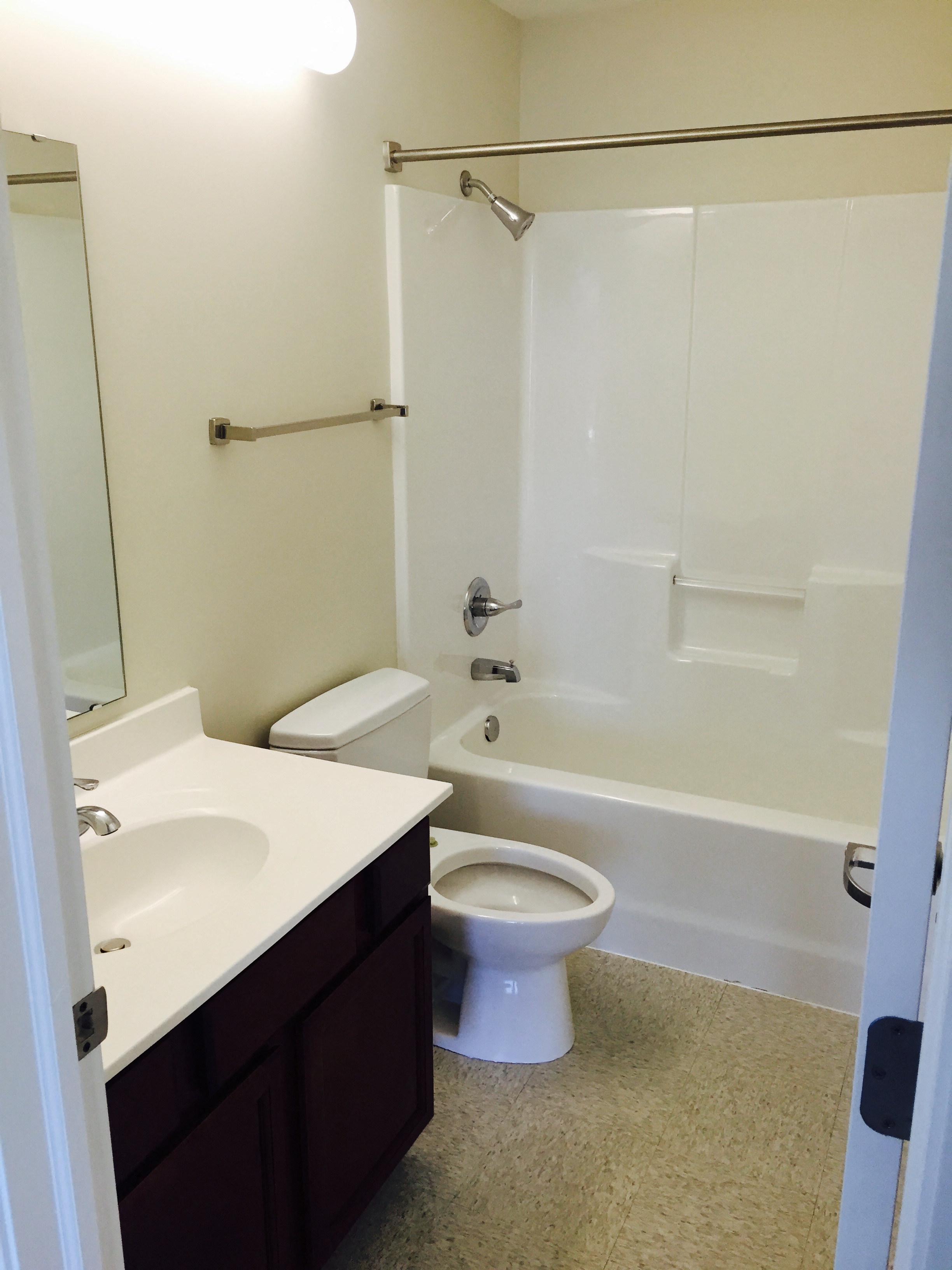 a bathroom with a shower toilet and sink