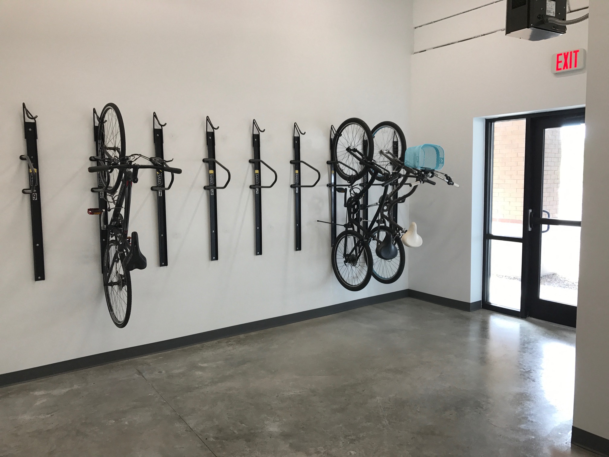a group of bikes hanging on a wall in a room