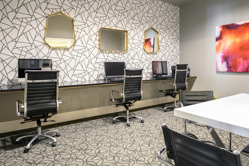 a conference room with four computer desks and chairs