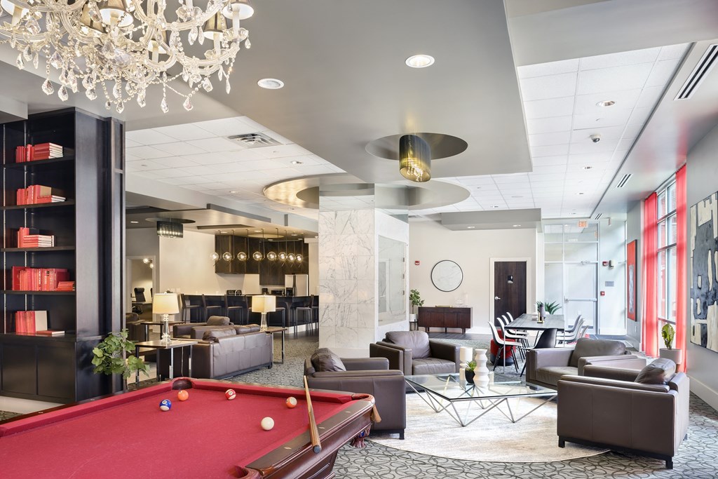 a lobby with a pool table and couches