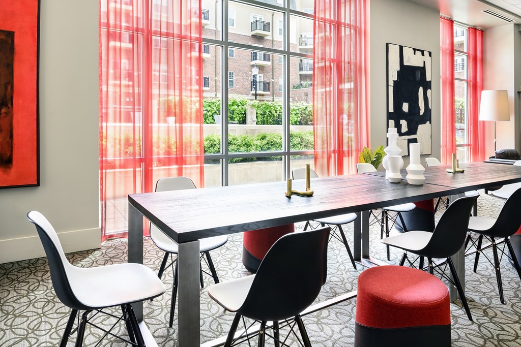a dining room with a table and chairs and a large window