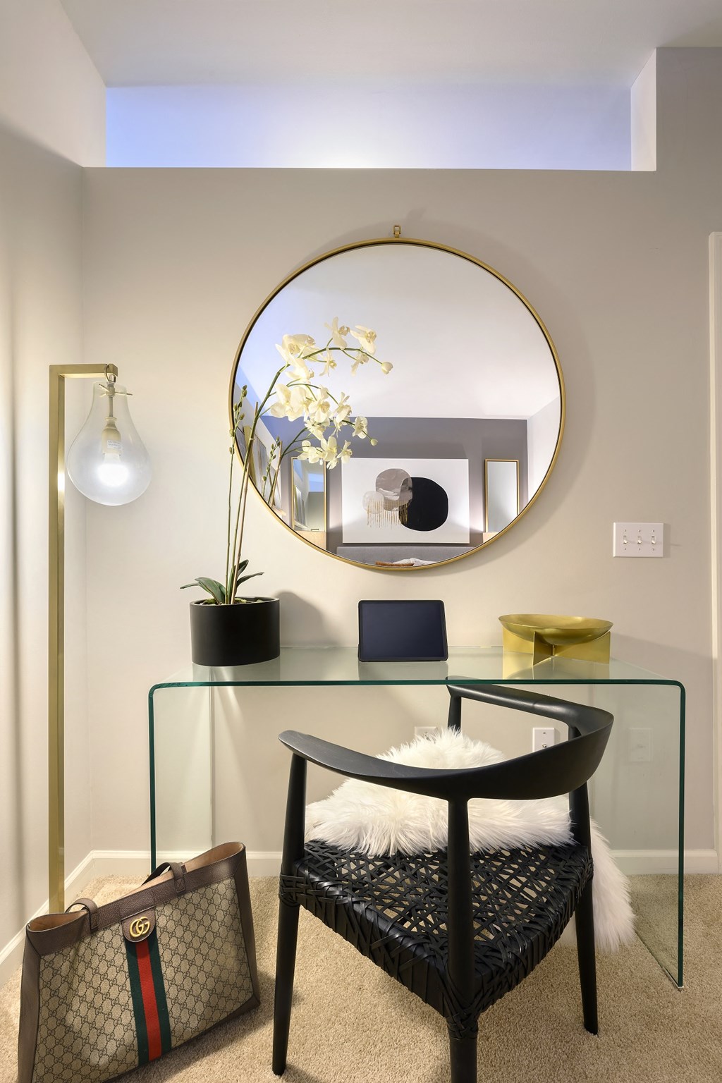 a desk with a mirror and a chair in a room