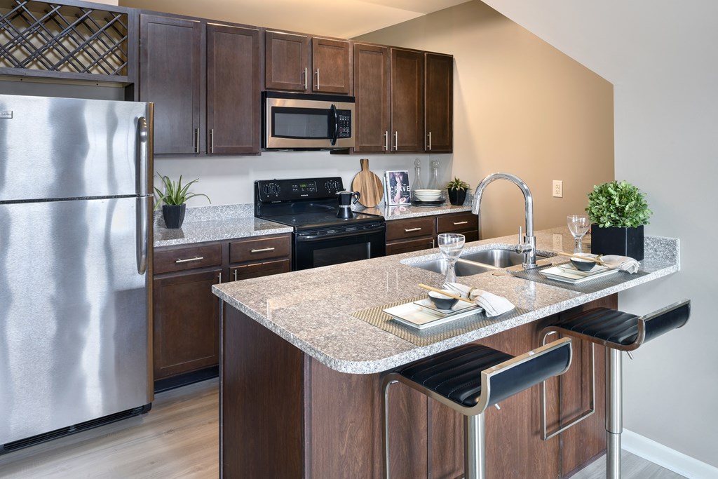 a kitchen with stainless steel appliances and granite counter tops