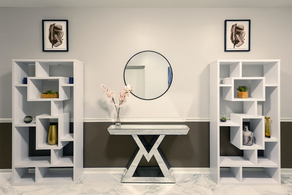 a white dressing table with a mirror and some shelving