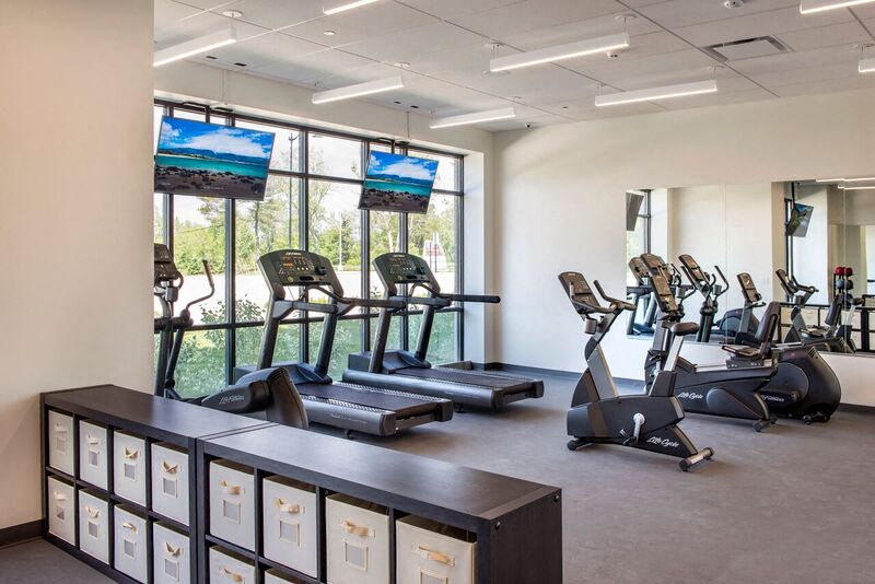 the gym has a lot of exercise equipment in it