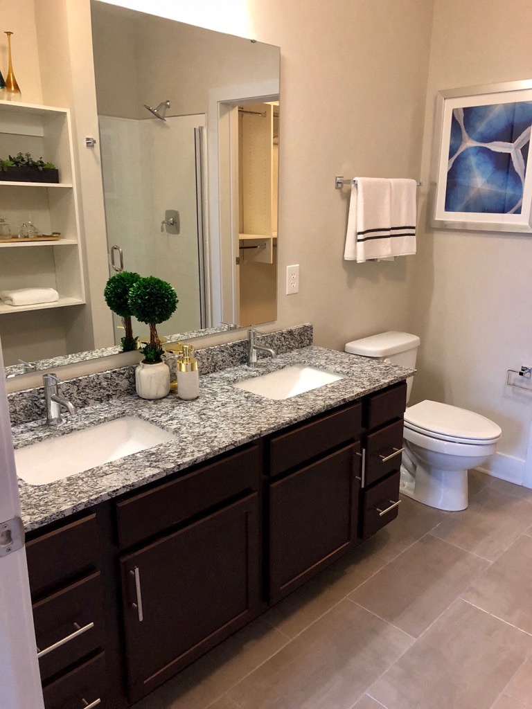 a bathroom with two sinks and a toilet