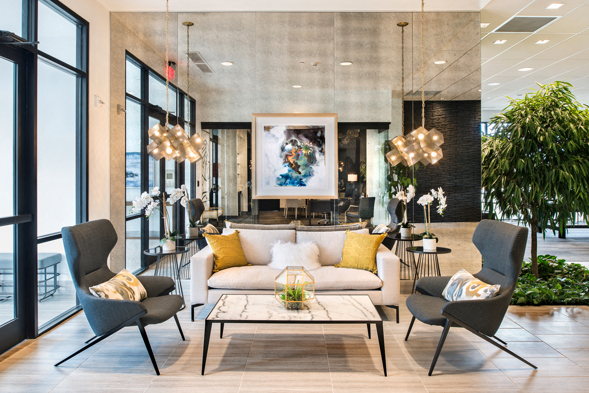 a living room with a couch and chairs and a table