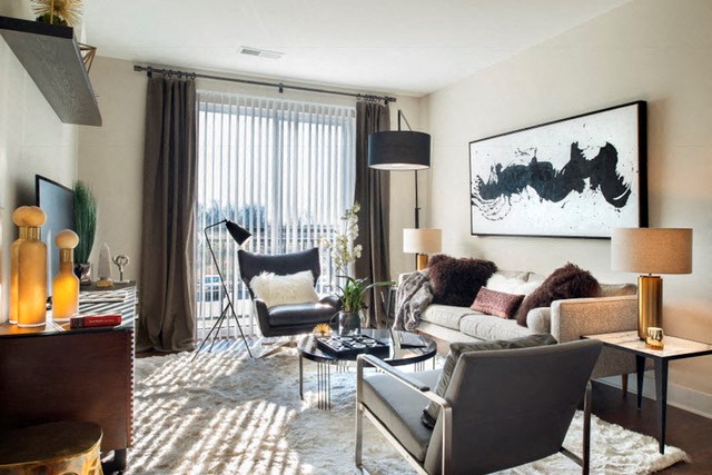 a living room with a couch and chairs and a table