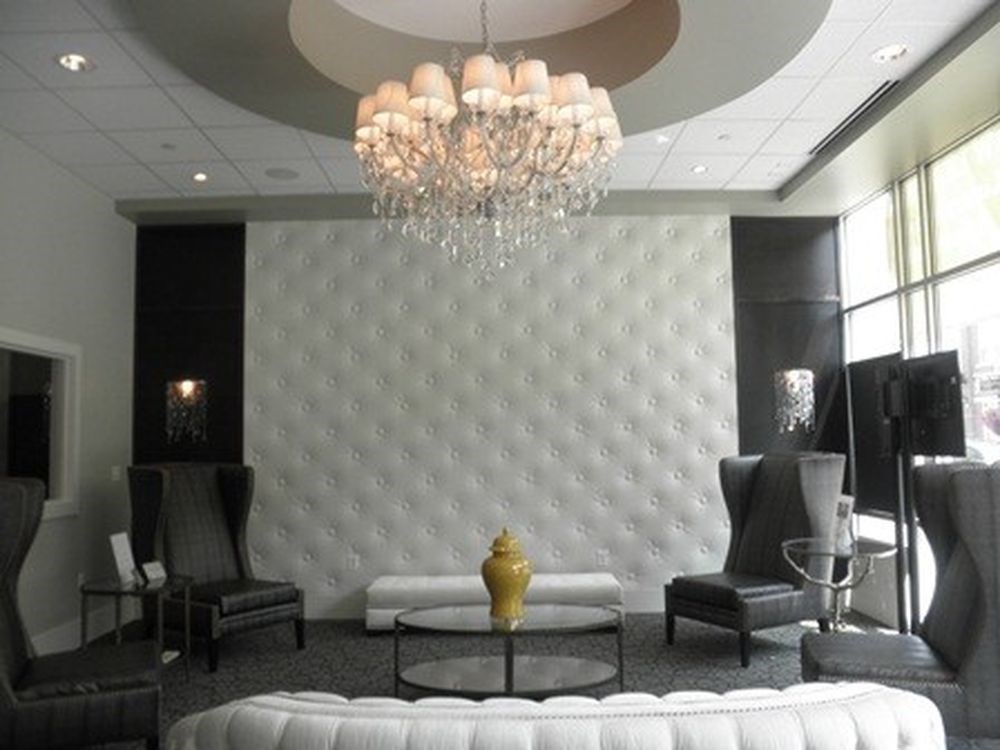 a living room with a couch and chairs and a chandelier
