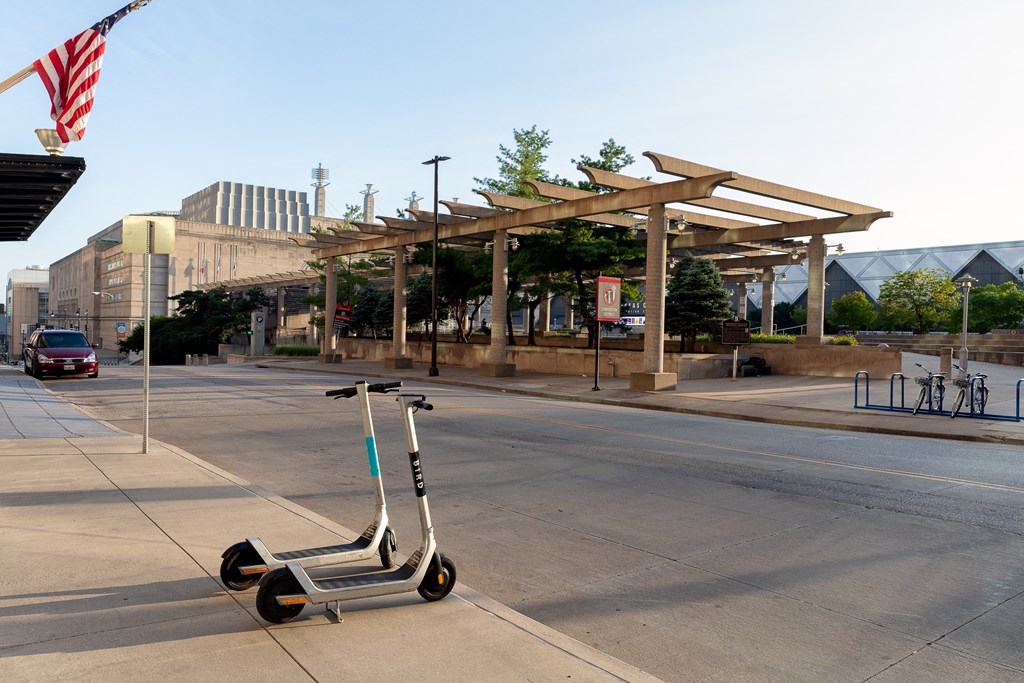 a pair of scooters parked on the side of a street
