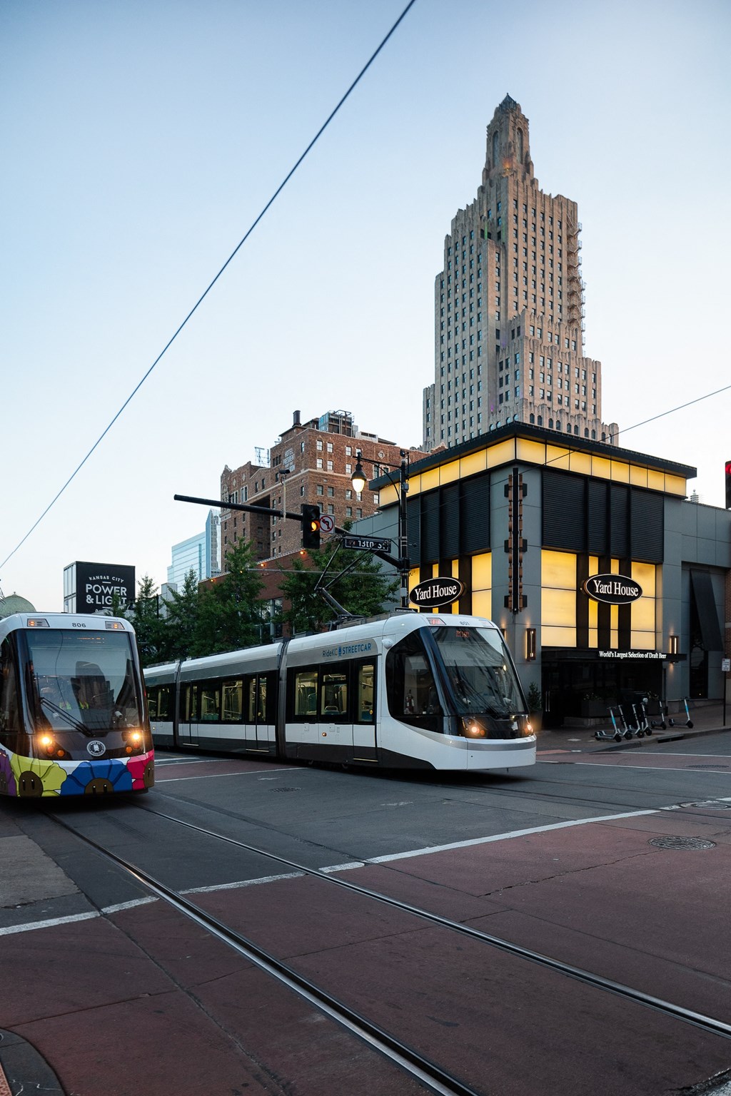 two trams on a city street in front of a building
