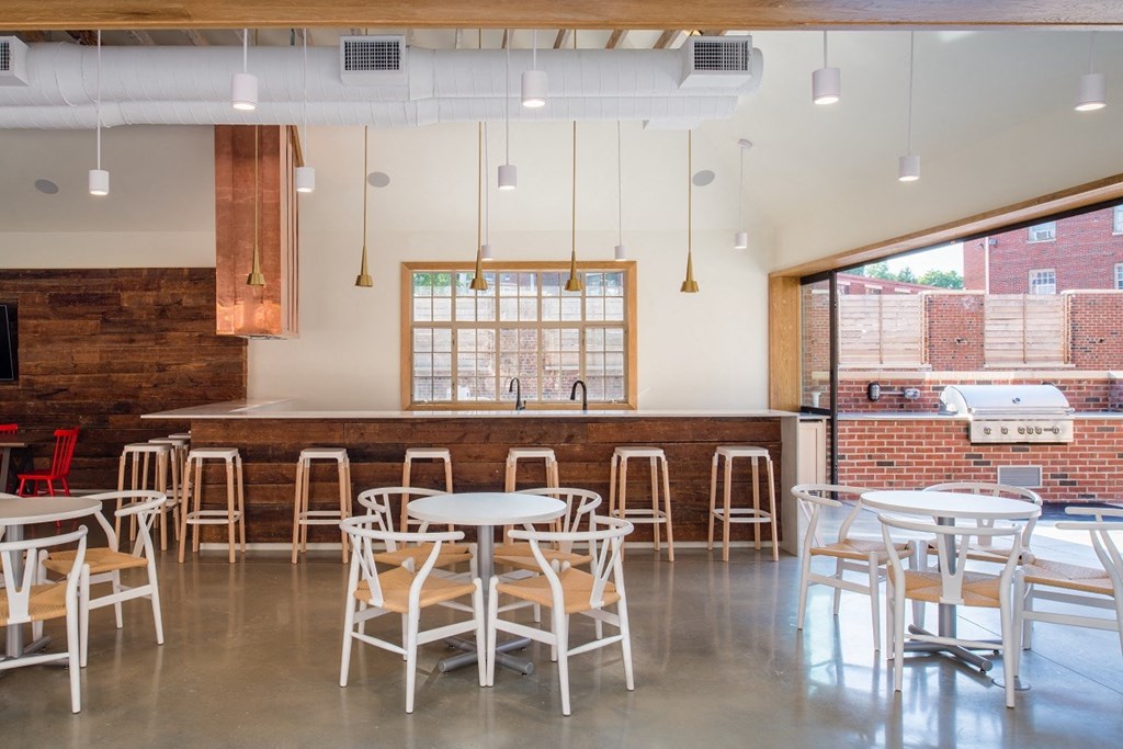 a dining room with tables and chairs and a bar