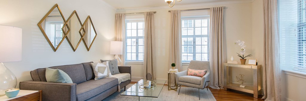 a living room with a couch and two windows