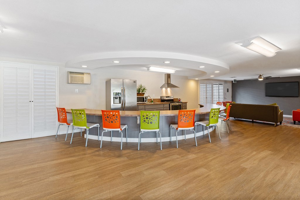 a conference room with a table and chairs and a kitchen at Terramonte Apartment Homes, Pomona, CA