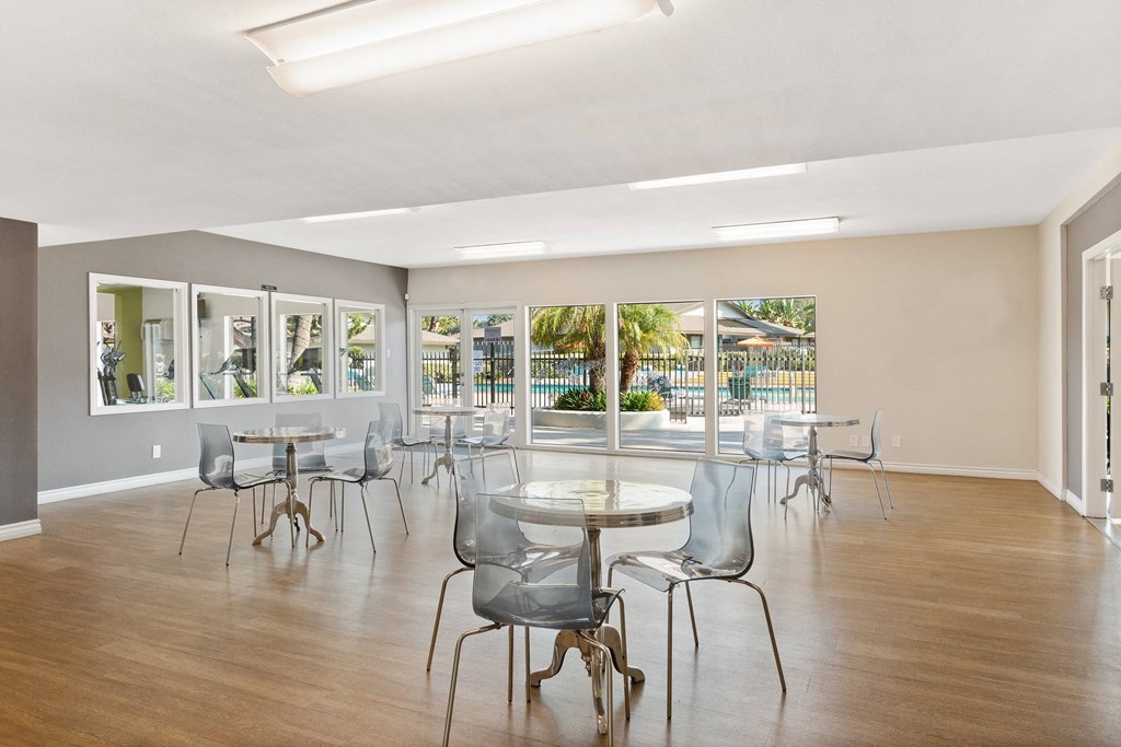 the preserve at ballantyne commons community room with tables and chairs and windows at Terramonte Apartment Homes, Pomona