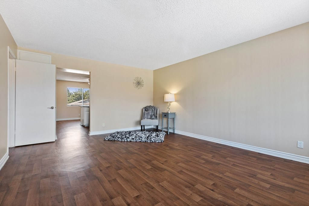 the spacious living room and dining room with hard wood flooring at Terramonte Apartment Homes, Pomona, CA, 91767