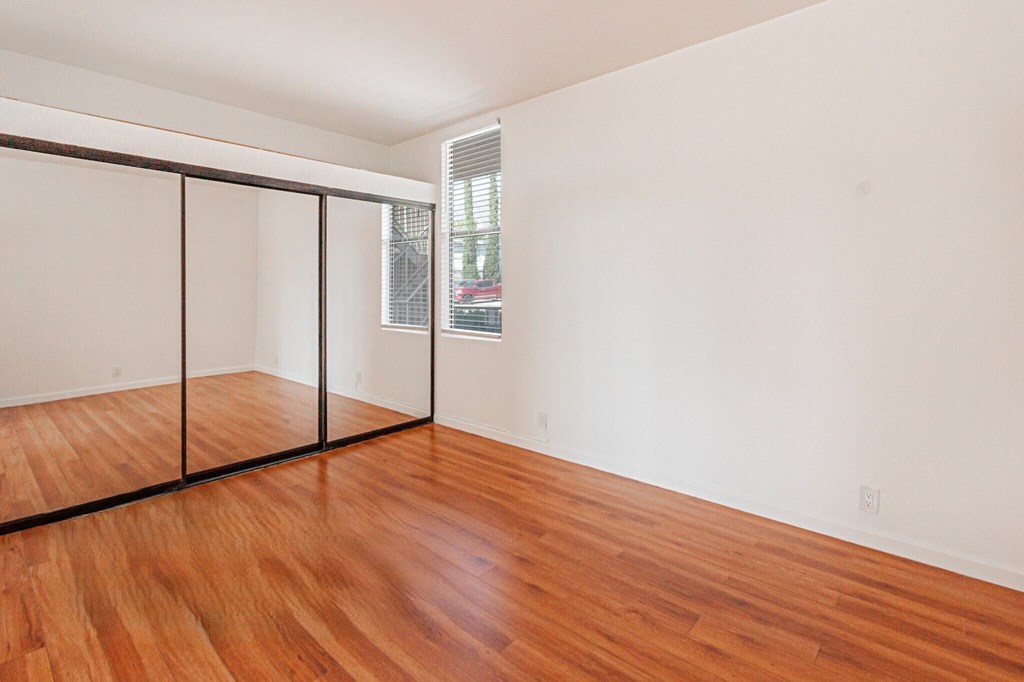 A room with a wooden floor and a sliding door.