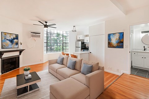 A living room with a beige couch and a coffee table.