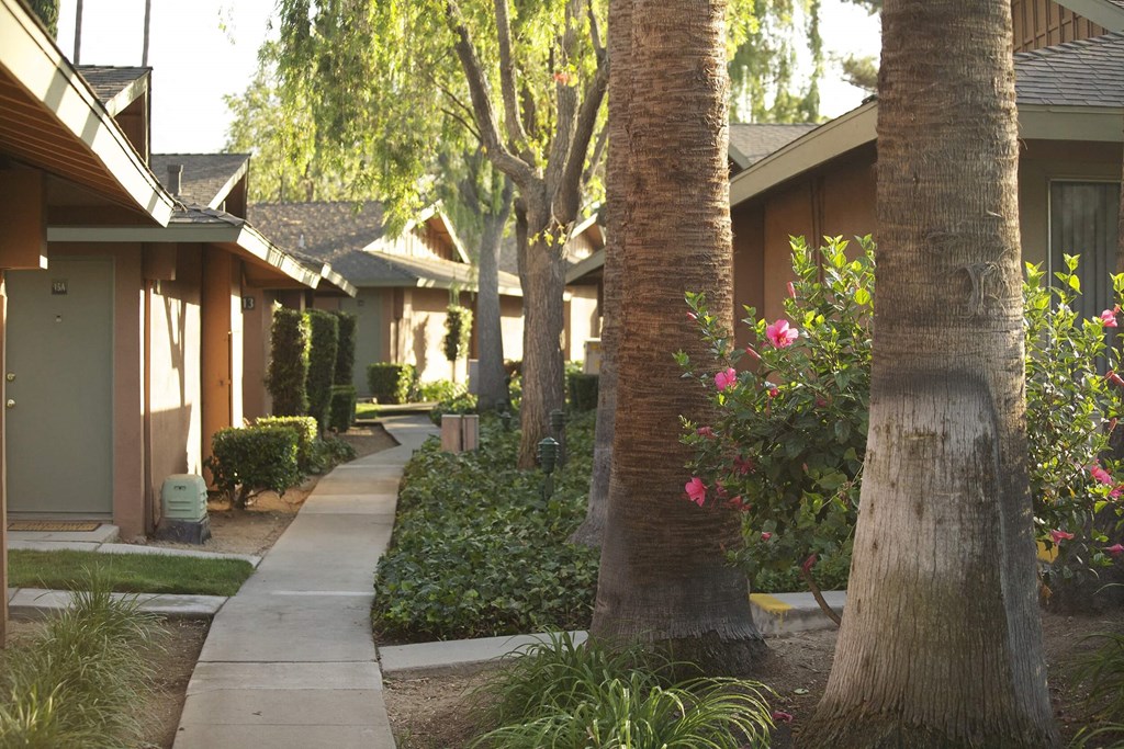 a row of houses with trees and a sidewalk at Terramonte Apartment Homes, California, 91767