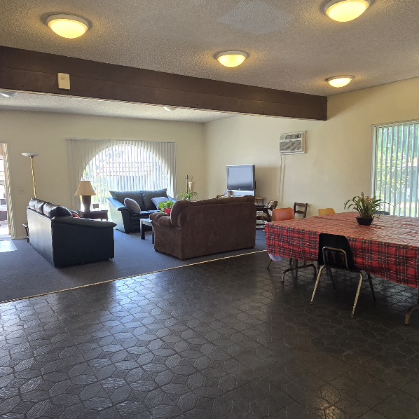 A living room with a couch, chair, and table.