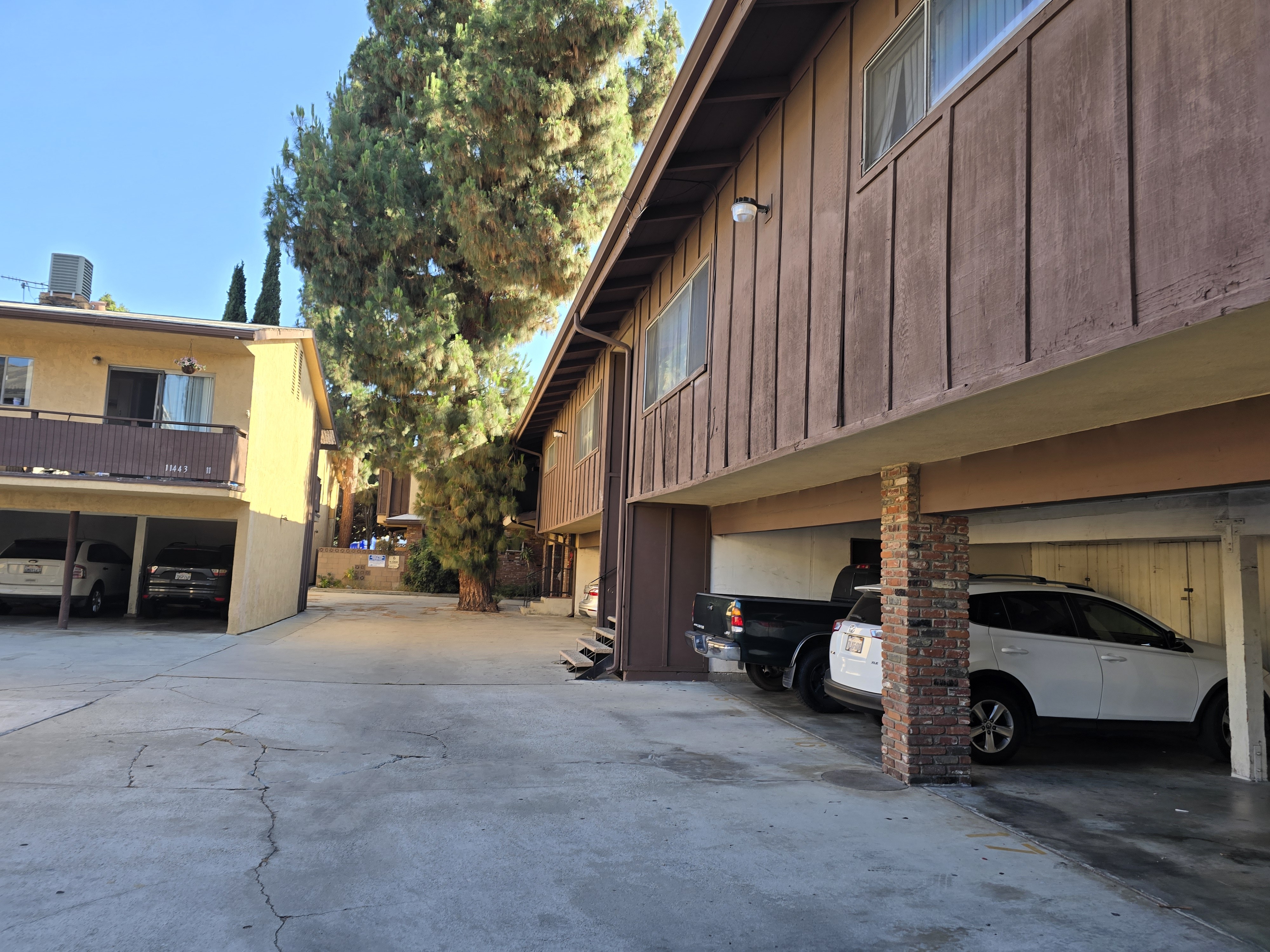 A parking garage with a white car parked in the bottom right.