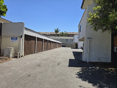 A parking lot with a blue sign on the left side.