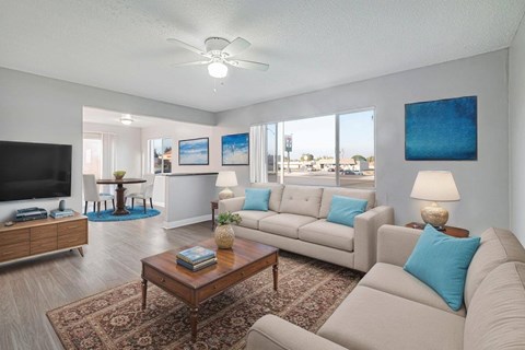 A living room with a brown coffee table and a grey couch.
