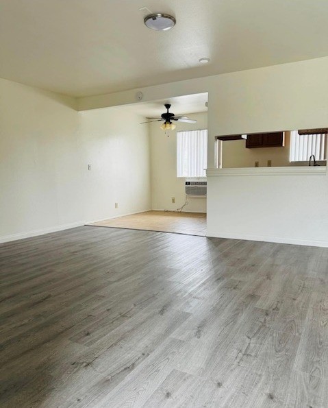 A room with wooden flooring and a ceiling fan.