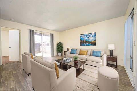 A living room with a white couch, a coffee table, and a painting on the wall.