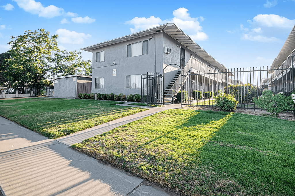 A residential area with a house and a fence.