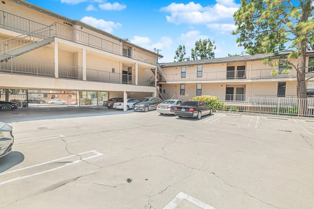 A parking lot with a car parked in front of a building.