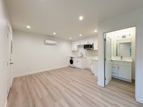 A spacious room with a washer and dryer in it.