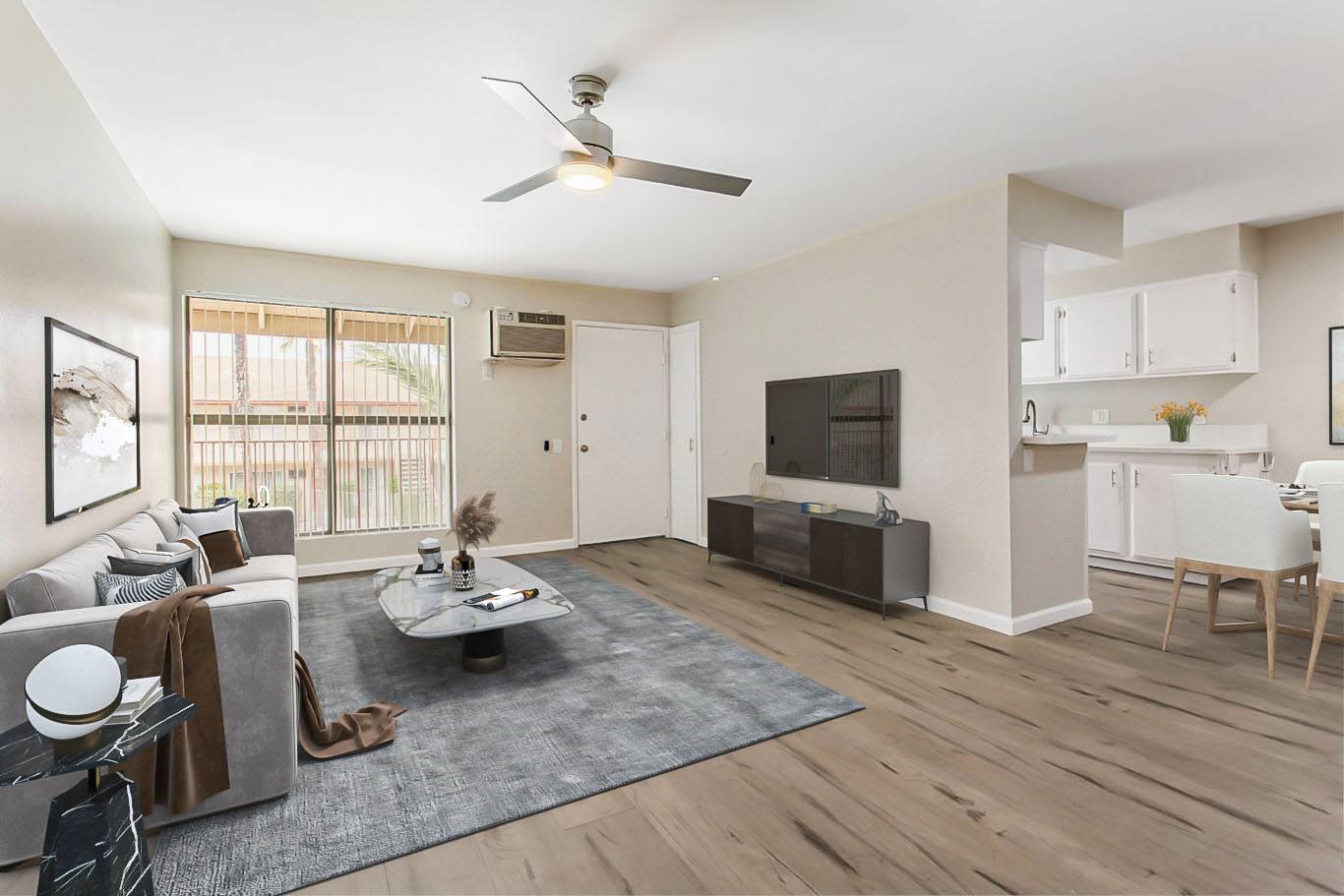 A living room with a grey rug and a white sofa.