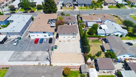 A residential area with houses and cars.