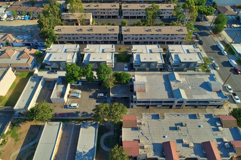 A bird's eye view of a residential area with houses and cars.