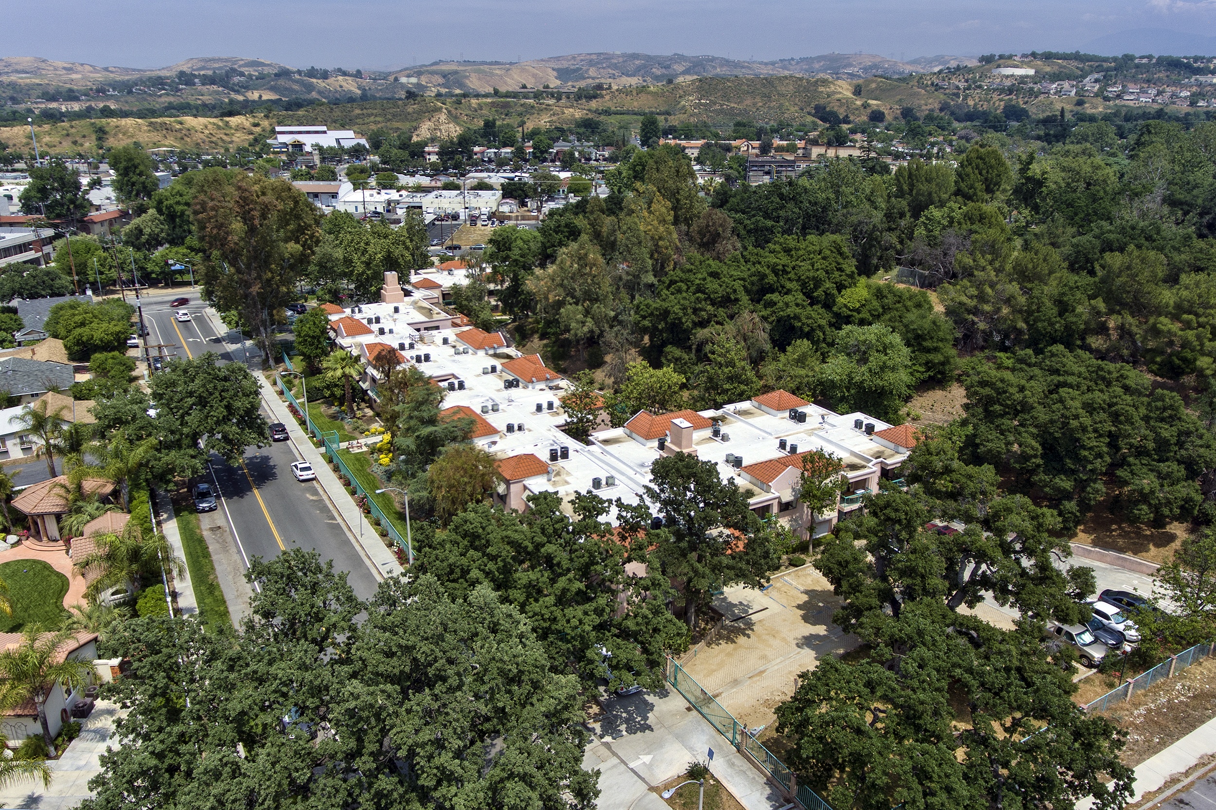 A bird's eye view of a residential area with houses and trees.