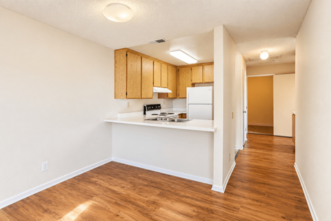 A kitchen with wooden cabinets and a white countertop.