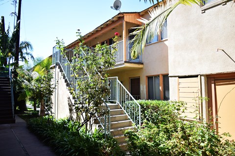 A building with a staircase and a balcony.