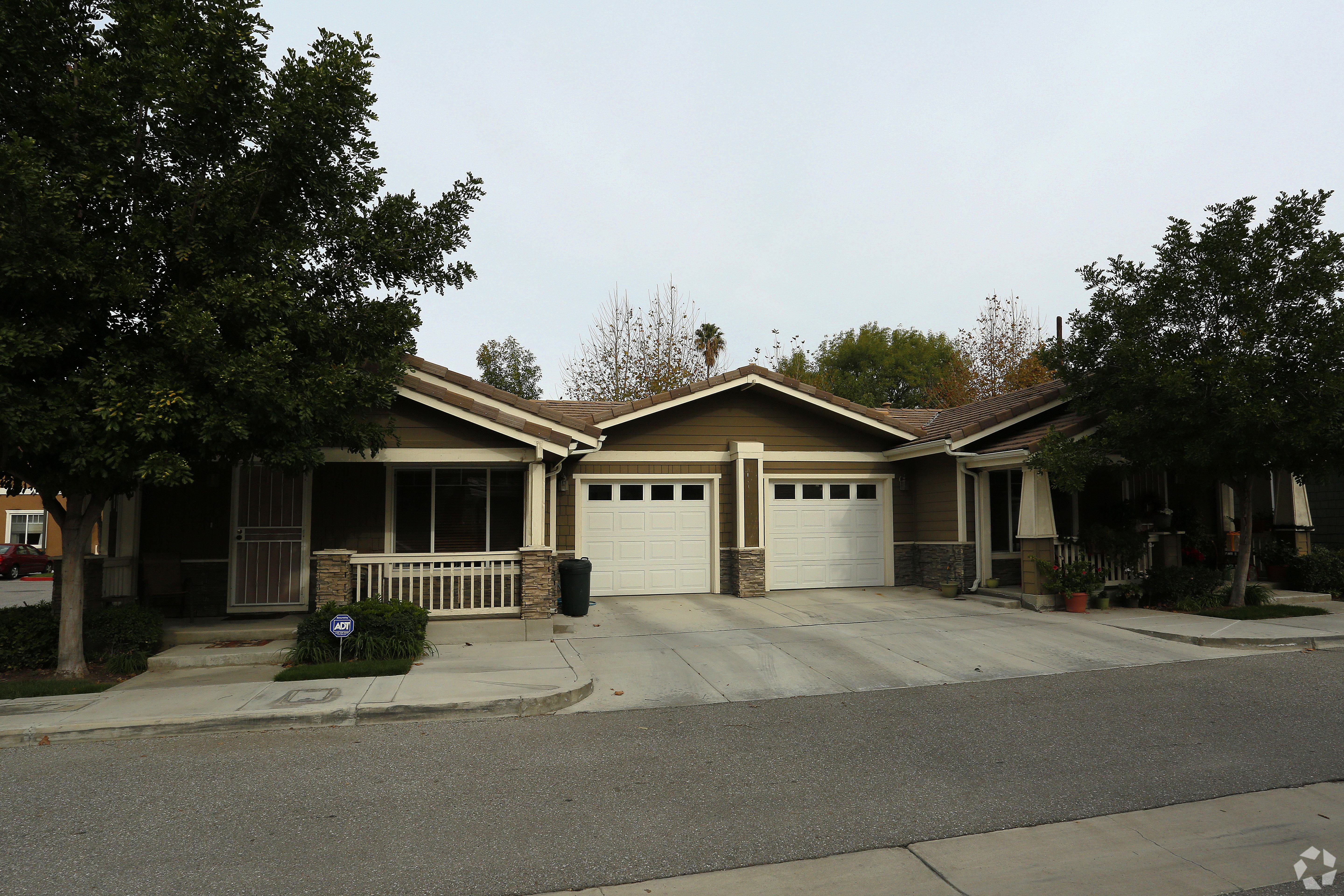 A house with a brown roof and a white garage door.