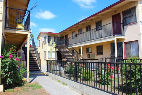 A row of apartment buildings with balconies and staircases.